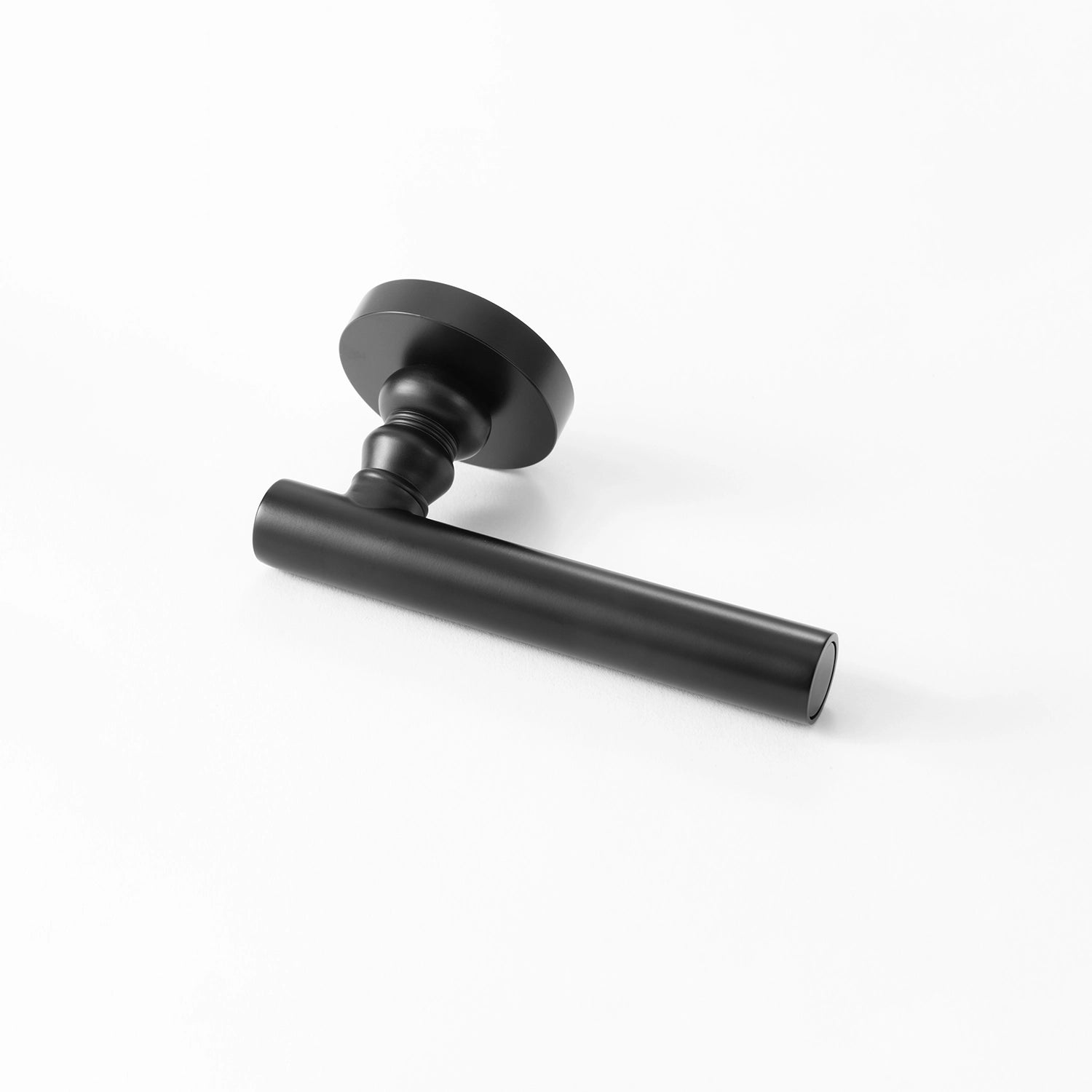 Alda black internal door handle with a round rose, sleek design, positioned horizontally on a flat surface.