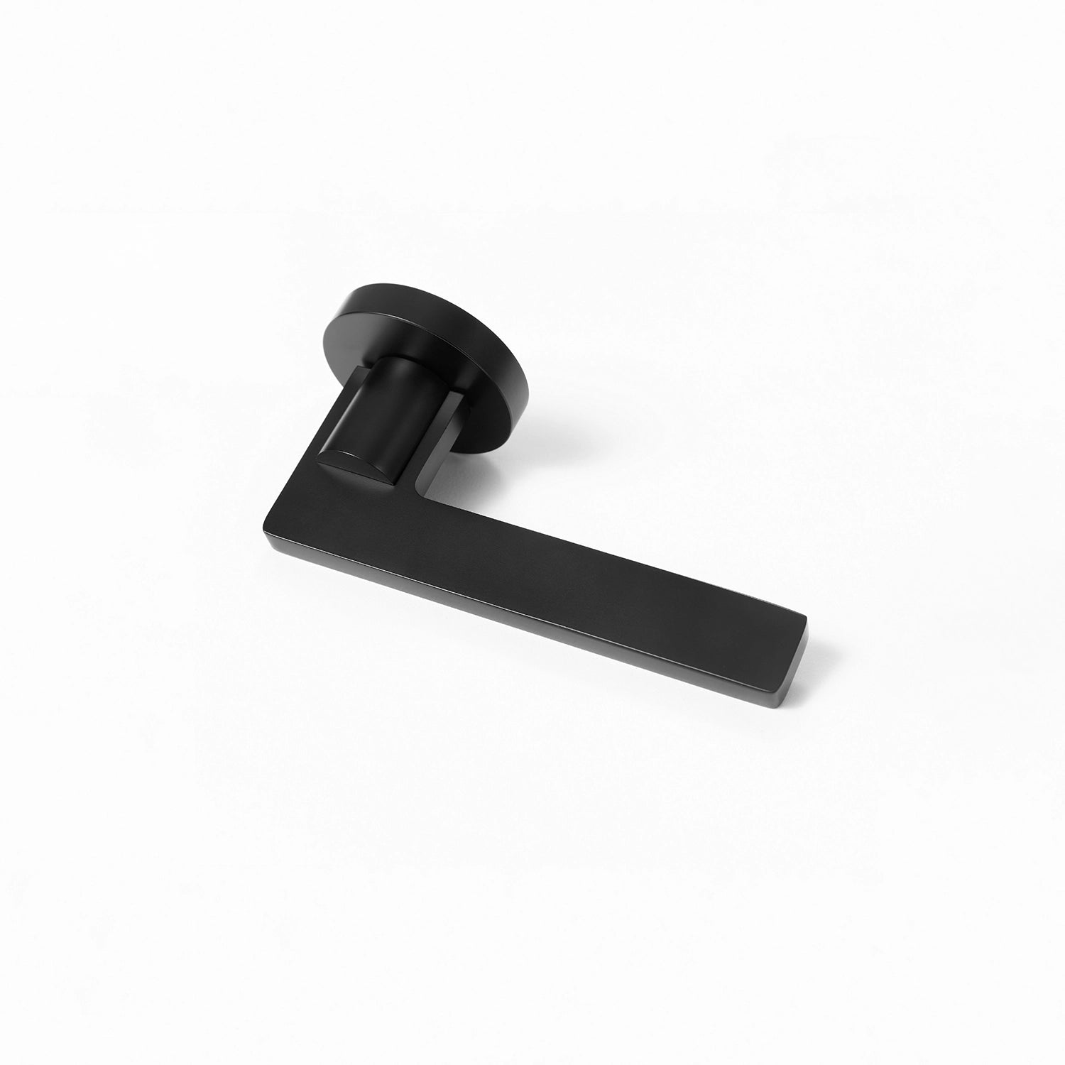 Filda black internal door handle with a round rose, positioned horizontally on a flat surface.