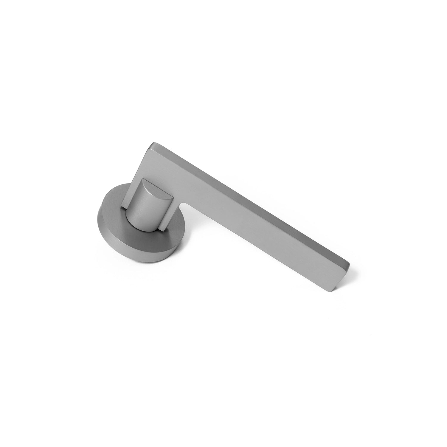 Filda nickel internal door handle with a round rose, positioned vertically standing on its base.