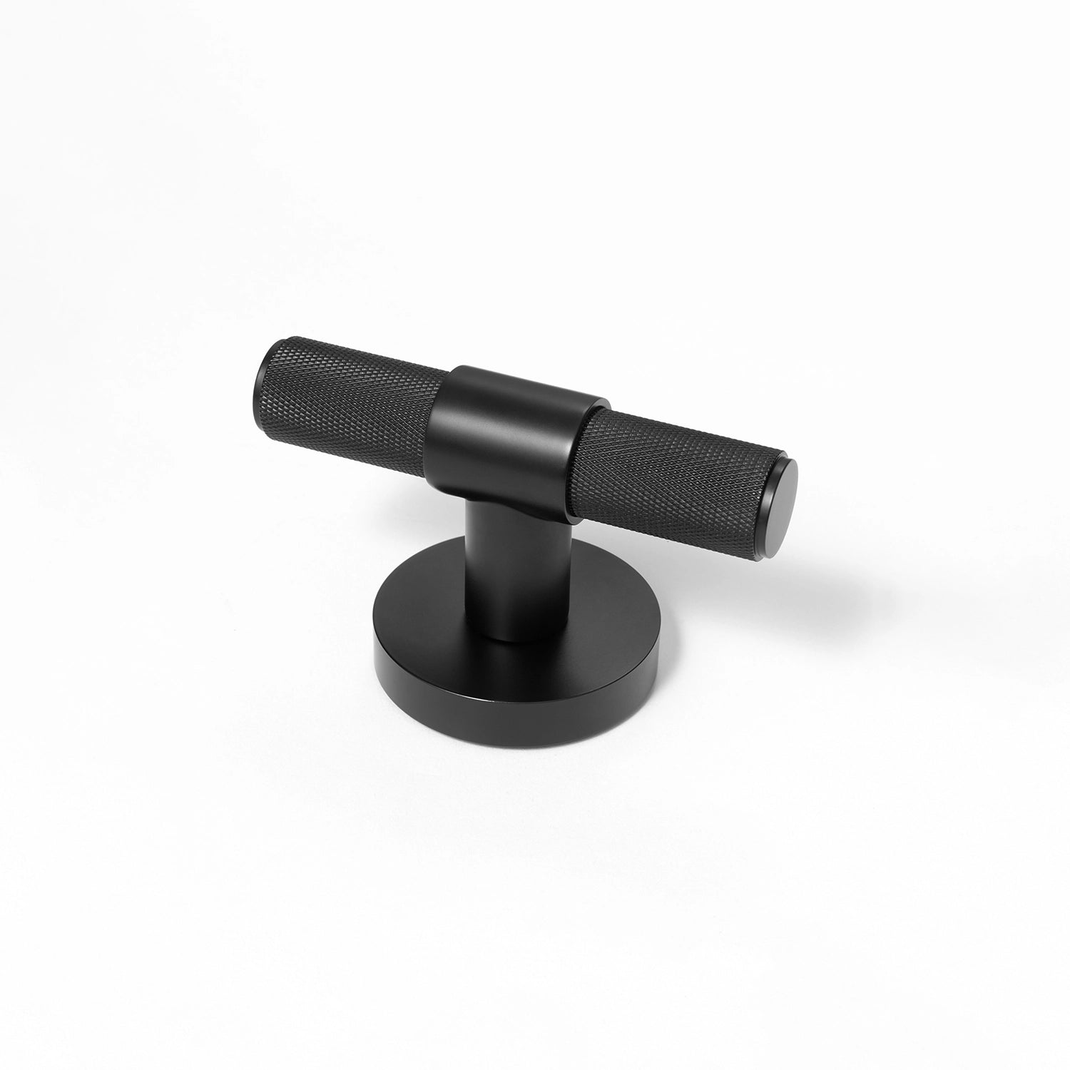 Heik black internal door knob with knurled pattern, standing upright on a round rose base.