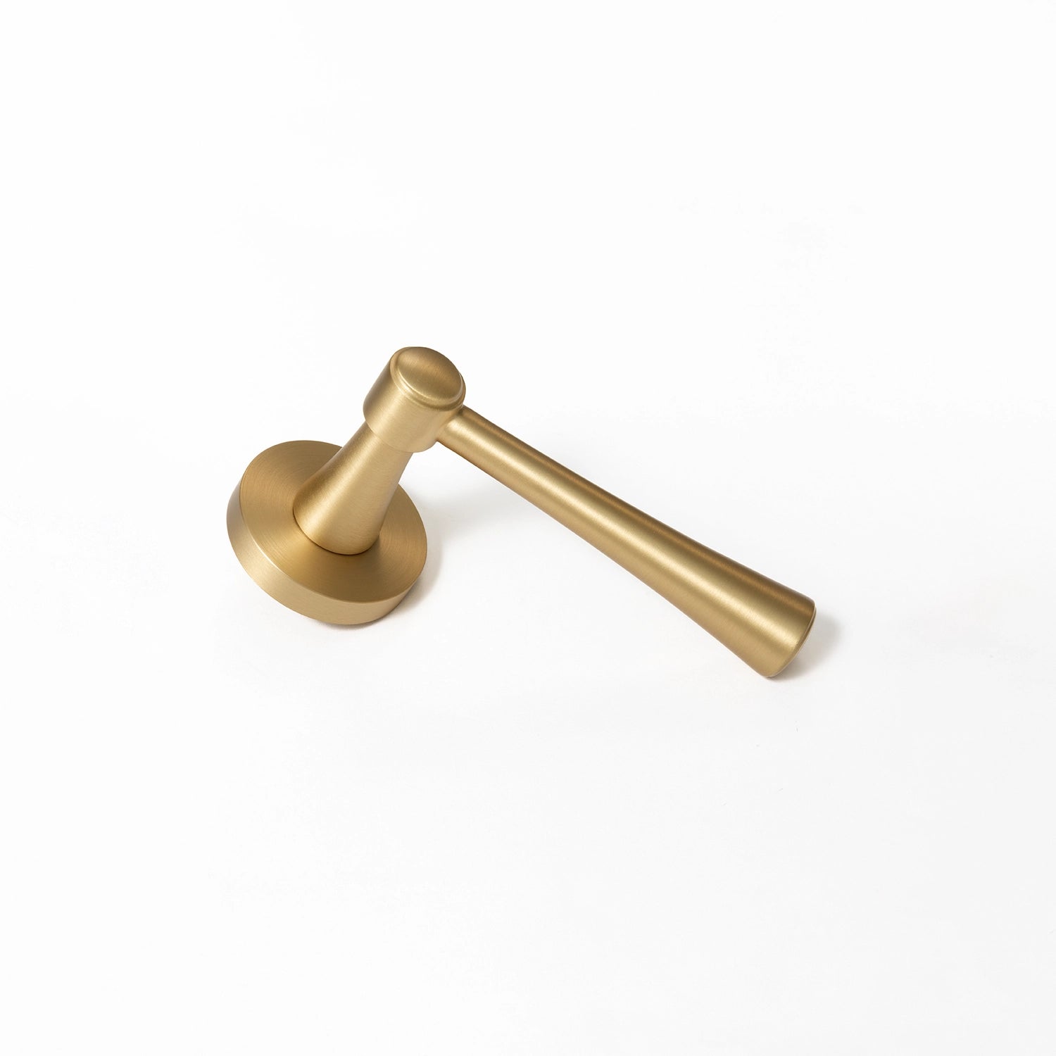 Hilda door handle in satin brass finish, positioned vertically standing on its base, showcasing streamlined cone design.