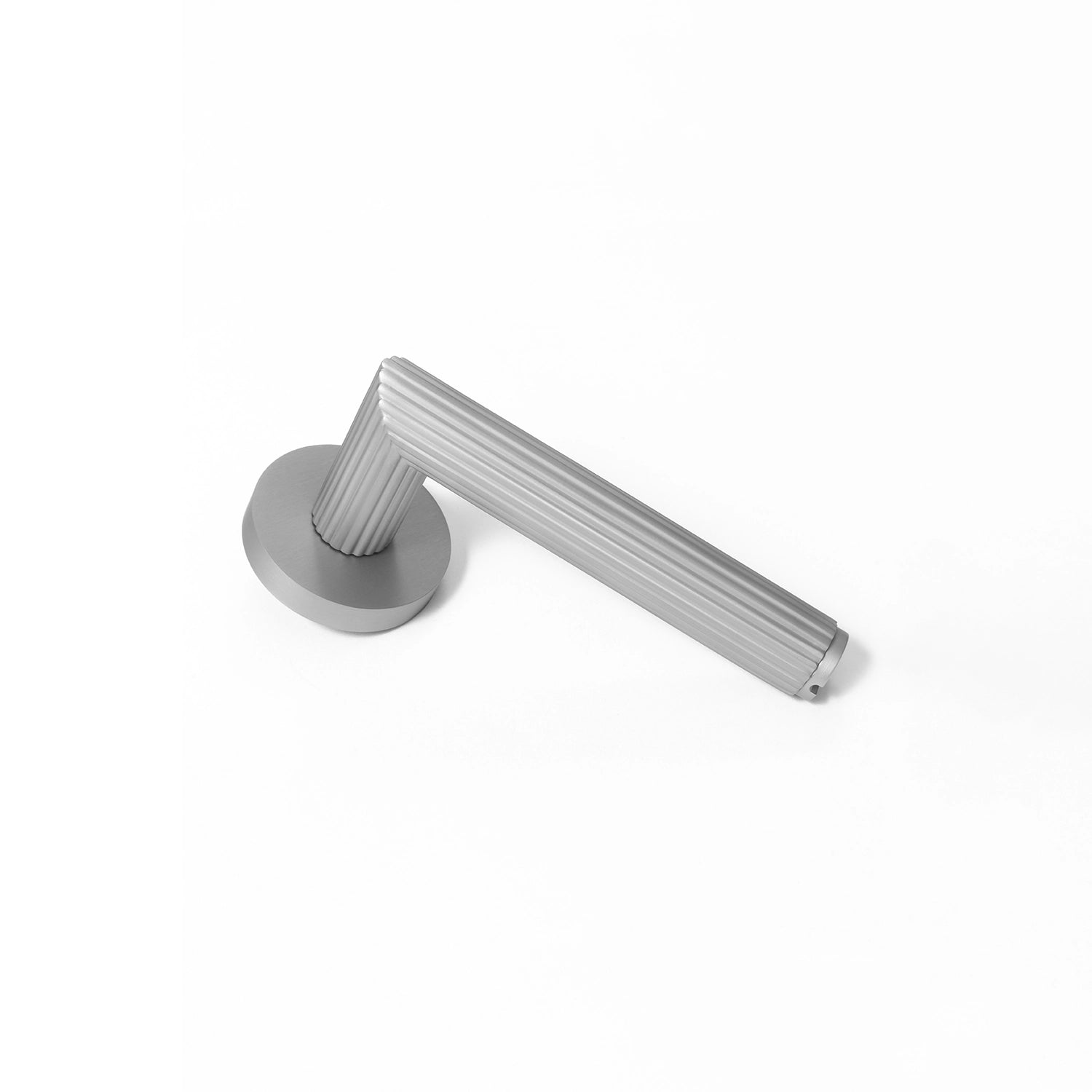 Midal door handle in nickel finish, positioned vertically standing on its base, showcasing a distinctive linear pattern for an elegant touch.