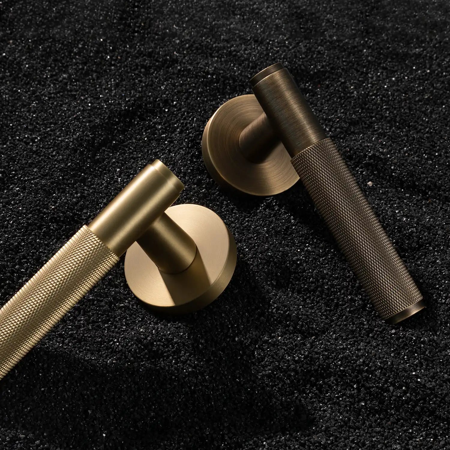 Svik-01 internal door handles with knurled pattern, featuring satin brass and antique brass finishes, showcased on layered slate stone background.