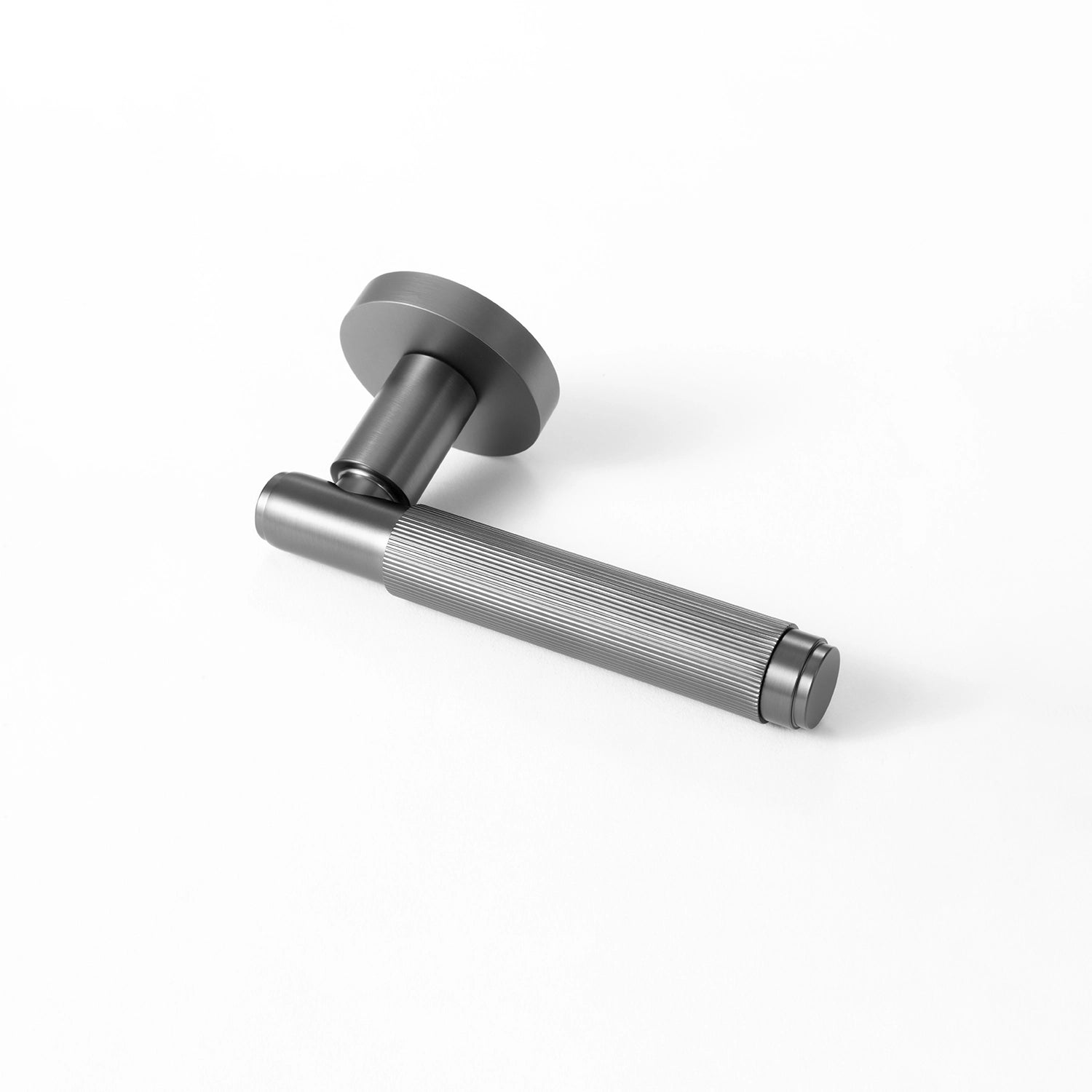 Svik-02 internal door handle in charcoal grey finish, positioned horizontally on a flat surface, showcasing a linear pattern on the gripping section.