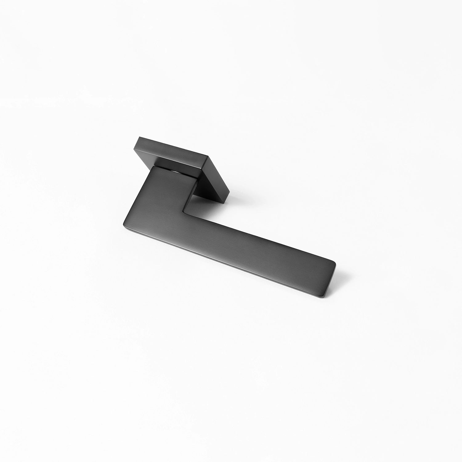 Tagg internal door handle in black finish, showcasing a minimalist square rose design and sleek geometric lever, positioned horizontally on a white background.