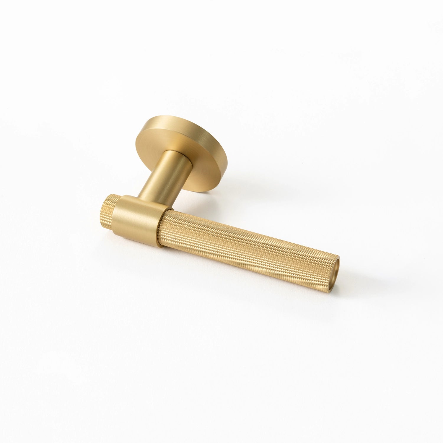 Tord-02 internal door handle in satin brass finish, featuring a partially covered knurled pattern on the grip area, placed horizontally on a white background.