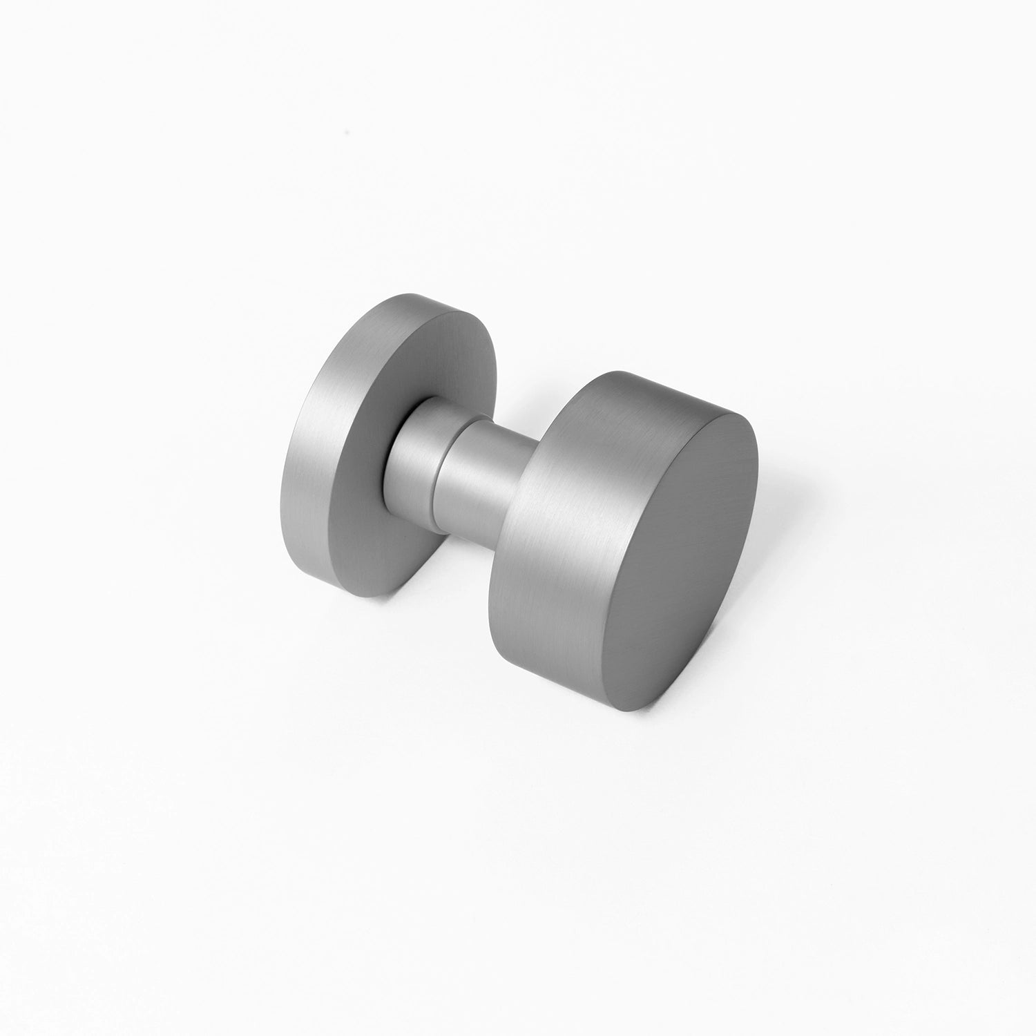 Solda round door knob in nickel finish, positioned at an angle on a white background, showcasing its minimalist and modern design.
