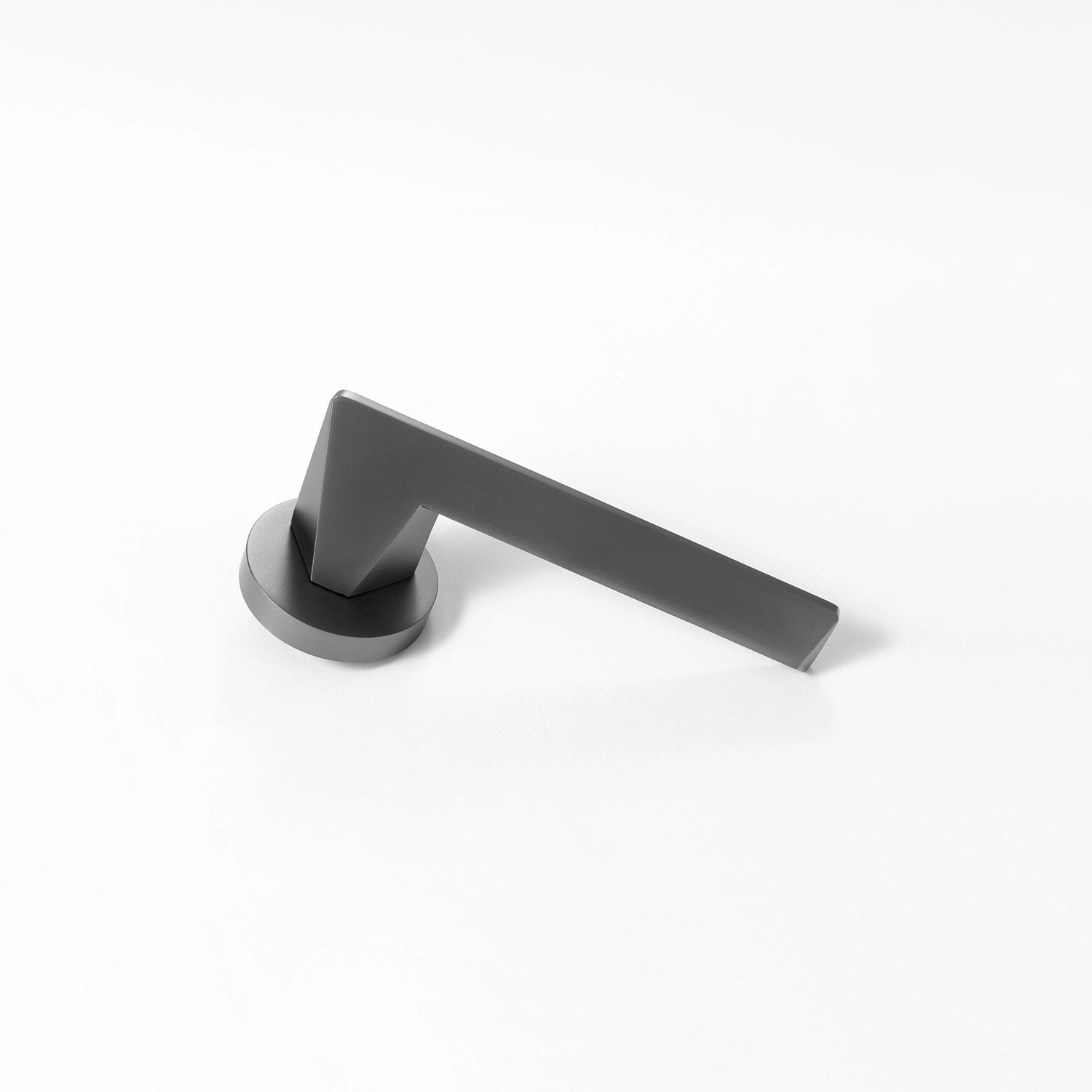 Tagg internal door handle in charcoal grey finish, featuring a minimalist round rose design and geometric lever profile, placed vertically on a white background.