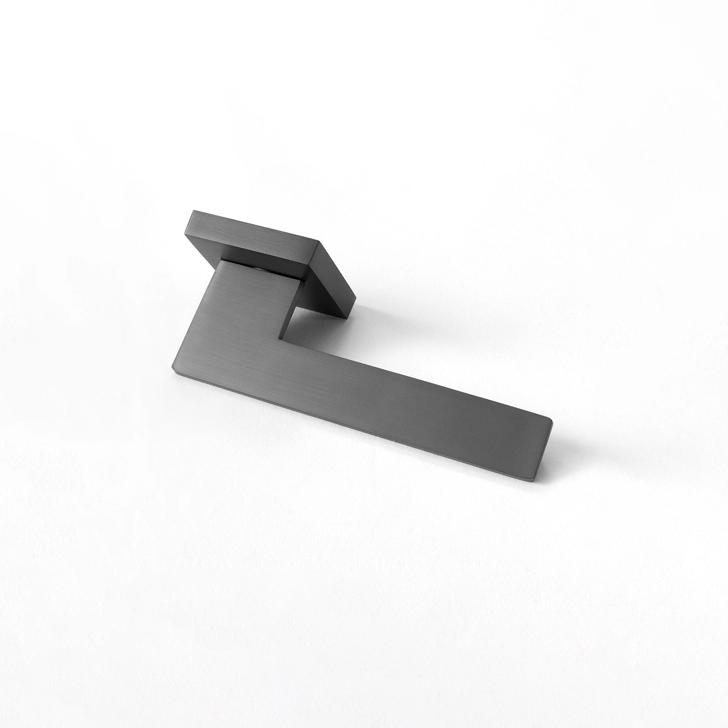 Tagg internal door handle in charcoal grey finish, showcasing a minimalist square rose design and sleek geometric lever, positioned horizontally on a white background.